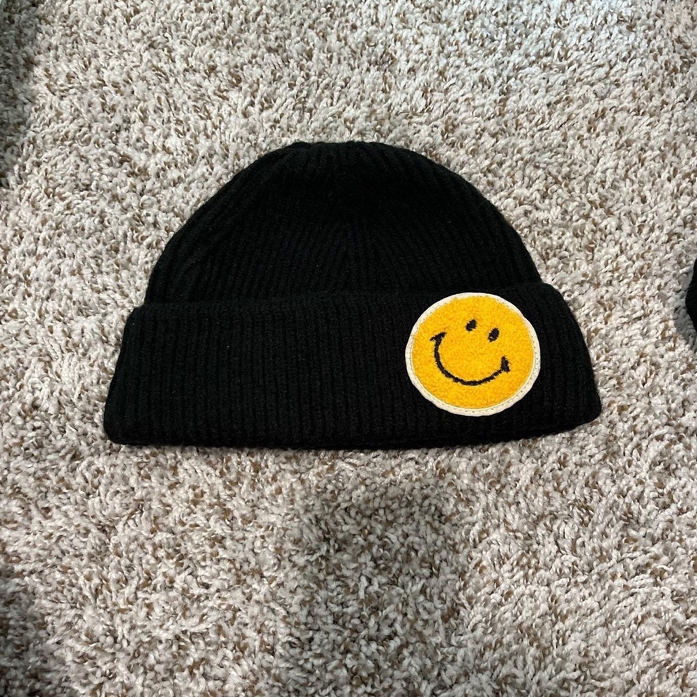 black beanie with a smiley face